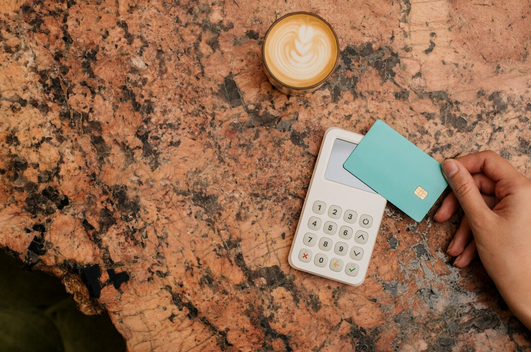 person using calculator with money