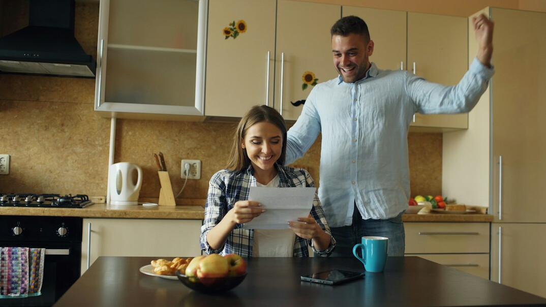 family discussing finances at kitchen table
